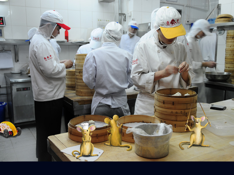 Tommy with friends watching while a rigorous quality inspection of Chinese dumplings is going on